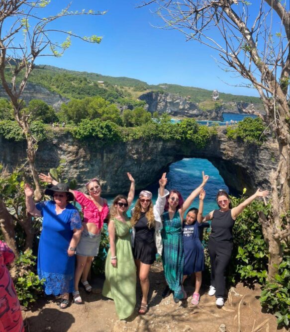 Group of travellers celebrating at Broken Beach, Nusa Penida, Bali